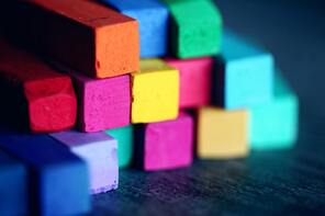 Colouful blocks of chalk arranged as building blocks